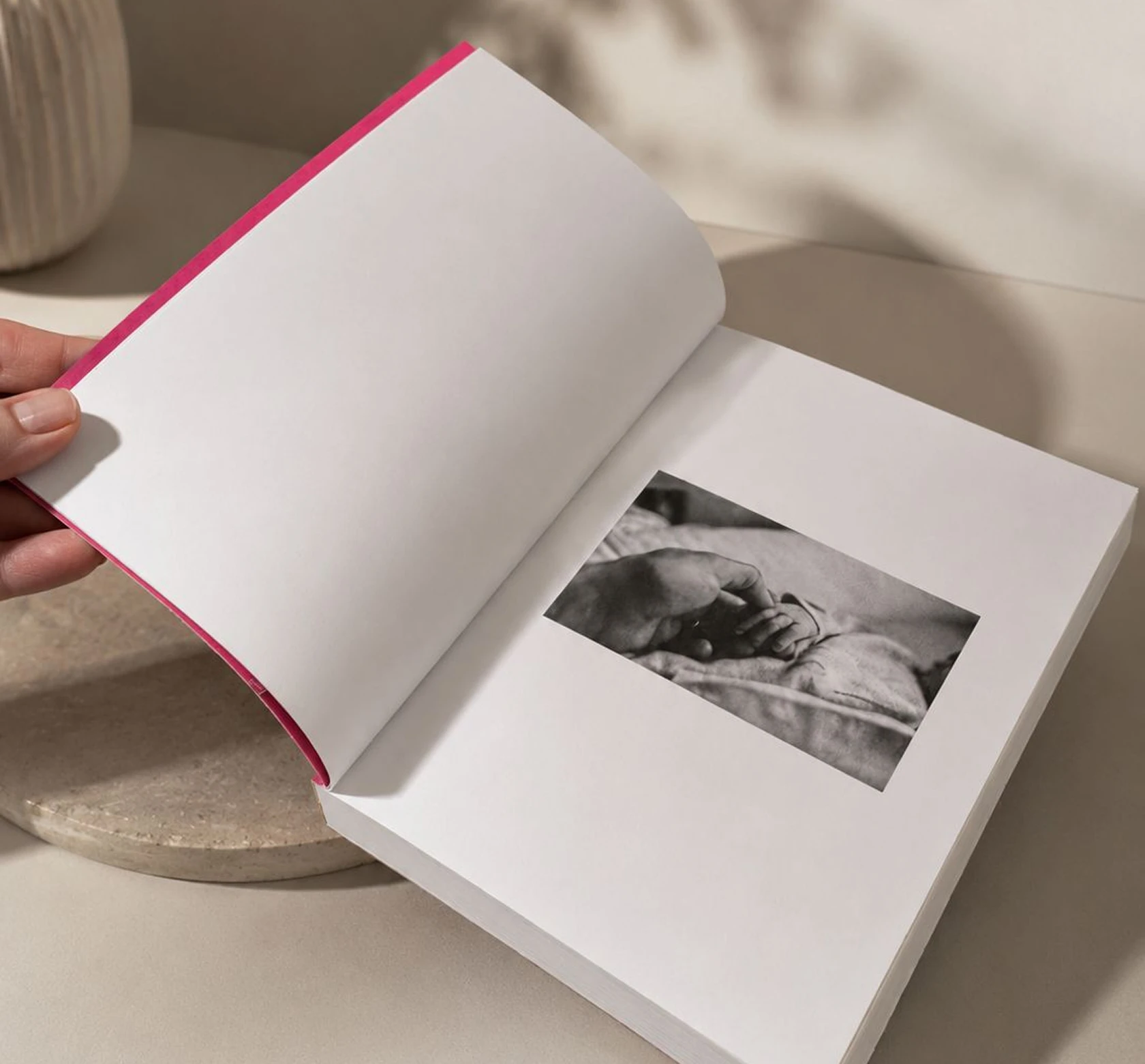 A paperback journal held open at a black and white photo page